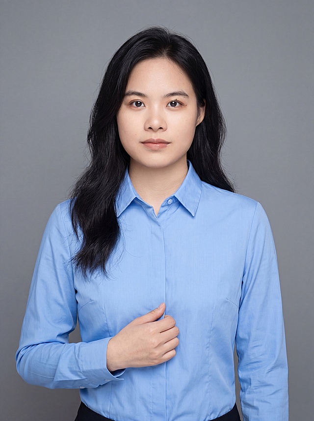 参考图中保留人物脸型、发型、年龄等特征生成职场形象照，标准焦段50mm，f/4光圈，平视视角，人物占画面70%，人物居中，入境范围头部及以下至臀部下方10cm(半身像)，左右留少量背景空间，头部与画面顶部保留5%空间，头部发型完整，头肩比例协调，人物结构准确，发质微微柔顺，微微蓬松。身穿纯蓝色高支精梳棉翻领正装衬衫，着装正式干练，通用职场专业稳重气质，身形匀称，姿态端正，身体挺拔。呈自然站姿，右手轻握西装前襟，肢体放松且自信。去除原图片的黑色外套和徽章配饰，保留脸型五官不变，简约微微中度灰色纯色背景，背景光线均匀柔和，强化色彩对比的高级感，极简干净。画质超高分辨率、细节清晰，现代精致感风格；肤质精细化处理；眼神直视镜头，目光坚定且澄澈，表情自然。清透自然裸妆，妆感轻薄轻透裸肌感，通透感肤质，肤质自然细腻，肤色健康均匀，雾面柔光裸肌感，保留真实皮肤细节。正面柔光补光，4800K中性光，面部光比1:1.5，色调明亮。中近景写实摄影，对焦清晰，高清保留皮肤细节。分辨率4K，去除人物之外的所有徽章配饰元素。严格按照图片内容生成。画面比例3:4