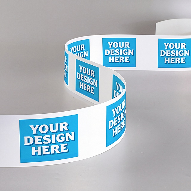 基于第一张图的S型白色胶带形态，将第二张图的蓝色方形YOUR DESIGN HERE图案作为单个印花单元，沿胶带走向等距均匀重复排布在白色胶带正面。胶带整体采用S型波浪曲线构图，从画面左下角起始，向前做圆润大弧度弯曲扭转，向后平缓延伸至画面右上角，形成流畅自然的蜿蜒动线。近景下半段弯曲胶带靠前放大，细节完整清晰；远景上半段胶带向后延伸收束，近大远小，塑造立体纵深。弯折处图案随曲面自然形变，贴合胶带拉伸弯曲的物理效果，模拟真实印刷成品效果。画面左下角靠前的完整图案块为视觉中心，完整清晰。胶带弯折弧度圆润顺滑，正反面露出，既展示印花正面，又露出纯白背面，体现胶带厚度与材质形态。浅灰色纯色极简背景，柔和均匀的静物柔光，胶带弯折内侧有自然浅阴影，曲面明暗过渡平缓，画面真实写实，商用样机风格。方形模块为单个印花单元，等距排列代表量产连续印花模式。