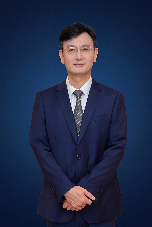 参考图1的商务蓝渐变背景风格，将图中人物的背景替换为同款精英商务深蓝色渐变背景，人物的五官、发型、服装、姿势、眼镜等所有细节完全保持不变，不要做任何修改，保持人物原样，只替换背景