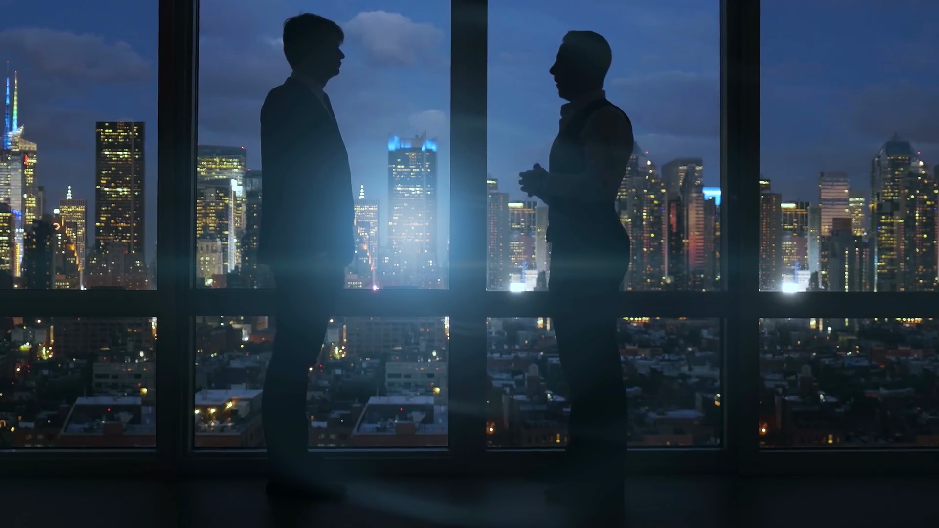 穿着工作服的白种人员工用电脑工作。以城市景观为背景。