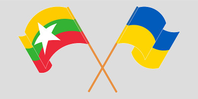 Crossed and waving flags of Myanmar and the Ukrain