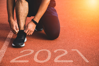 新年还是开始直概念。近距离观看刻有2021年铭文的运动员跑步成功和新成就的鞋子。在日落时分。