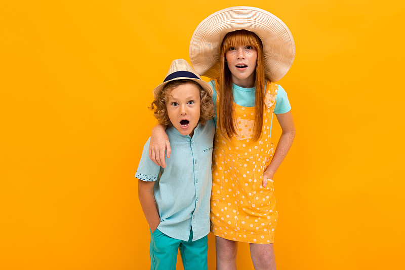 Two surprised red-haired brother and sister are lo