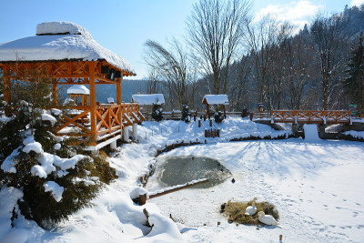 白雪覆盖的城市公园的冬季城市在晴朗的晴天与明亮的蓝色天空。乌克兰喀尔巴阡冬季城市耶尔姆切。