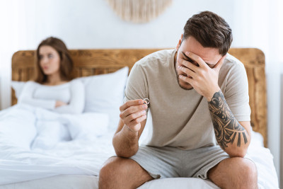 婚姻观念危机。伤心的丈夫手里拿着结婚戒指