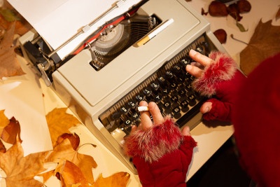 Writer's hands cold and smoking on the typewriter