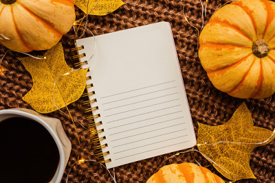 Autumn frame made of pumpkin, notebook, cup of cof
