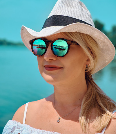 Reflection in sunglasses. Yacht near the pier. Gir