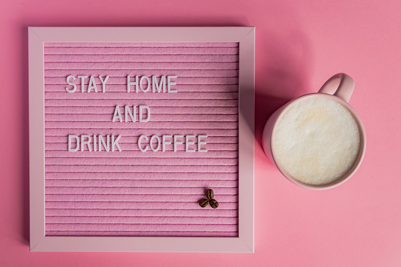 Top view of Pink Coffee cup with cappuccino and qu