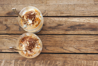 木桌上放着两杯装在玻璃里的affogato