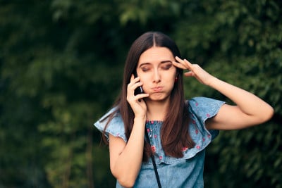 焦虑的女人在户外打电话