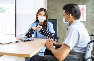 年长的亚洲人坐在轮椅上护理家望着窗外和思考。孤独的老人独自在家度过一天。家庭人寿保险的概念。