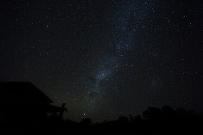 一对夫妇在巴厘岛的屋顶上看星星。