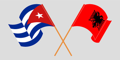 Crossed and waving flags of Albania and Cuba