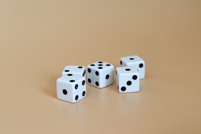 5个骰子在柔软的棕色背景上。
