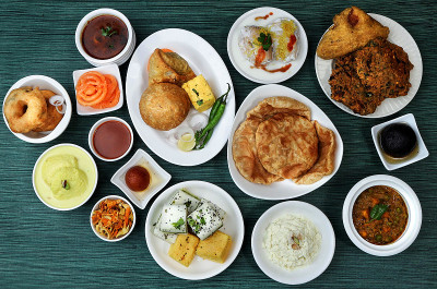 木制背景的什锦印度菜。Dhokla,kachori,samosa,vada,jalebi,jamun