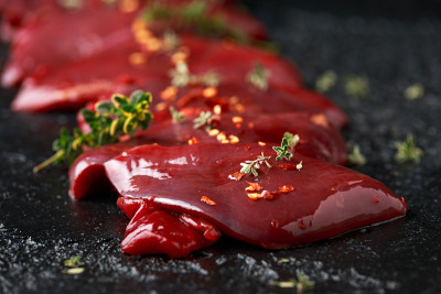 准备好的鸽脯肉和调味料混合在木板上烹调