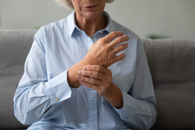 生病的老妇人检查手腕上的心跳