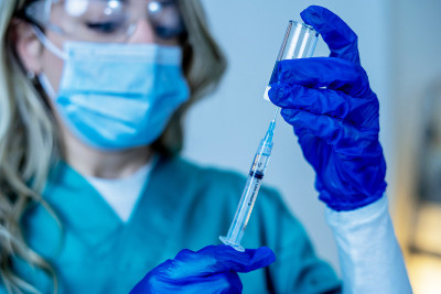 Doctor, nurse, scientist hand in blue gloves holdi