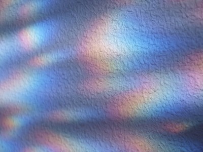 White stipple effect wall with rainbow lights text
