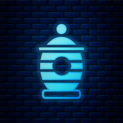 Glowing neon Funeral urn icon isolated on brick wa