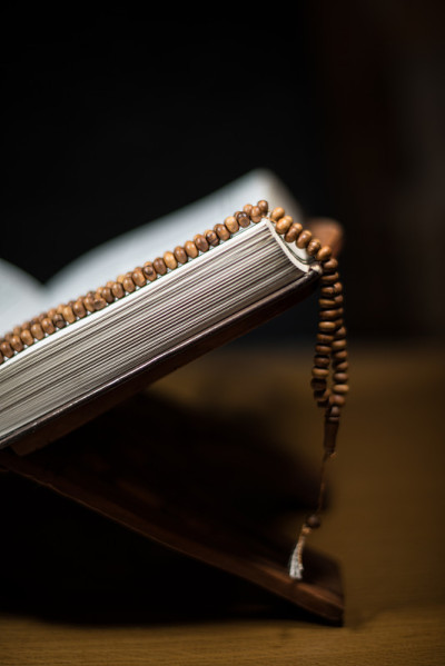 pages of holy koran and prayer beads at the book