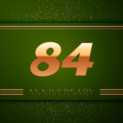 现实84周年纪念庆祝标志。绿色背景上的金色数字和金色五彩纸屑。彩色矢量模板元素为您的生日派对