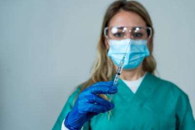 Doctor, nurse, scientist hand in blue gloves holdi