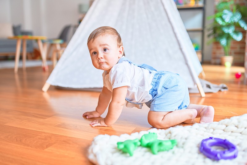 美丽的幼童在幼儿园爬行