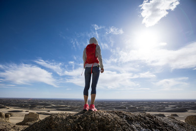 Successful woman trail runner  on sand desert dune