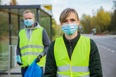 Volunteers collecting used disposable medical mask