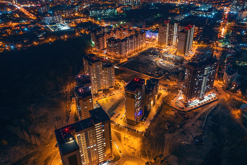 空中全景图，无人机飞行在夜间城市沃罗涅日与照明道路和高层建筑