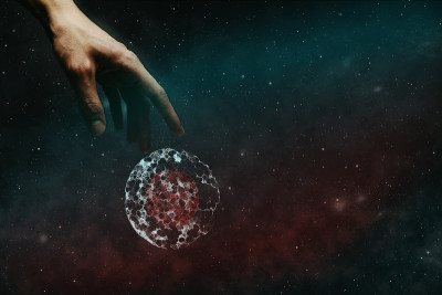 人的食指触碰细胞分裂。无限空间中的星云尘埃。混合媒体。