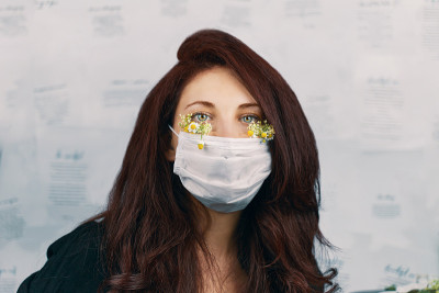 Young attractive woman in floral face mask