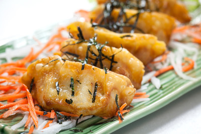 白色的桌子上放着带海藻的日式煎饺