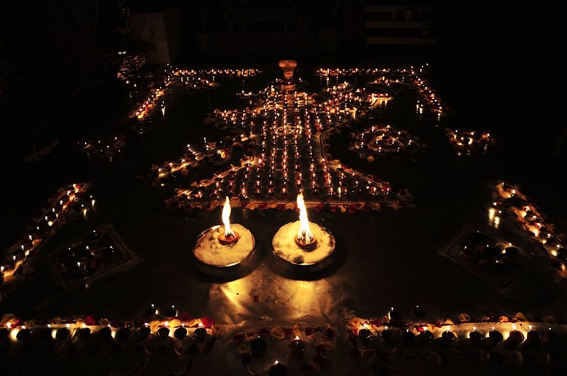 装饰油灯或燃烧蜡的传统排灯节Diwali Diya油灯与湿婆灵加排列成象征印度教主湿婆的三叉戟(三叉