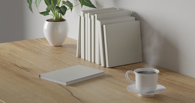 3d渲染工作桌与白色背景。木桌上放着空白本子、绿色植物和咖啡杯。最小的工作区。简单墙体室内设计概念模