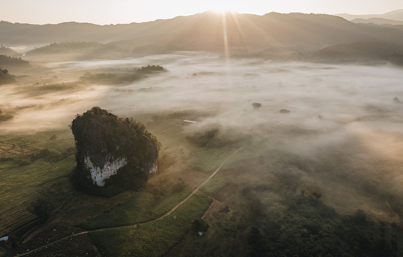 Aerial view of limestone mountains cover by the mi