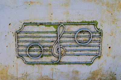 Old metal texture with the image of a treble clef 