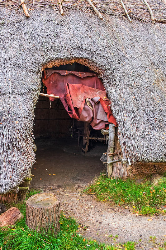 在一个用兽皮重建的史前时代的稻草小屋开放