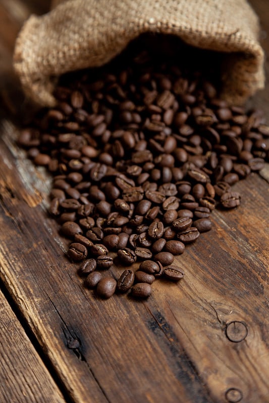 Bag of coffee on a wooden table. Coffee beans are 