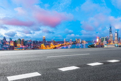 晚上，上海的天际线和现代建筑与空的公路，中国。