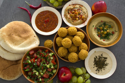 Colorful photo of different Israeli meals on a tab
