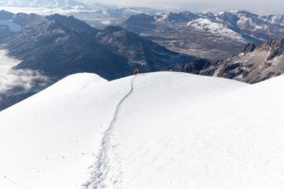 玻利维亚，登山者徒步攀登雪道山脊。