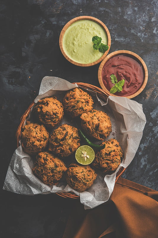 Palak OR Methi Pakora是一种印度小吃与绿色薄荷酸辣酱和红酱，选择性的焦点