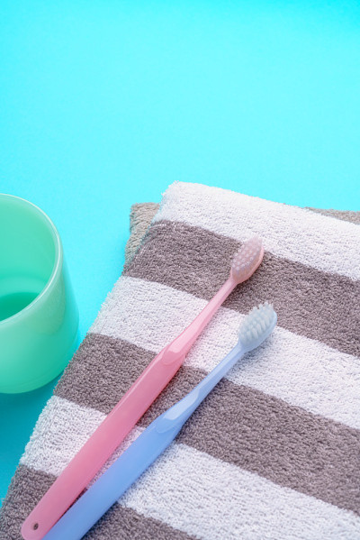 The toothbrushes, cup and towel