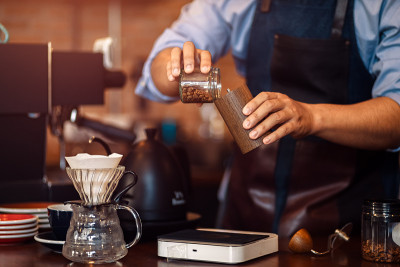 the barista hands on manual grinder coffee for gri