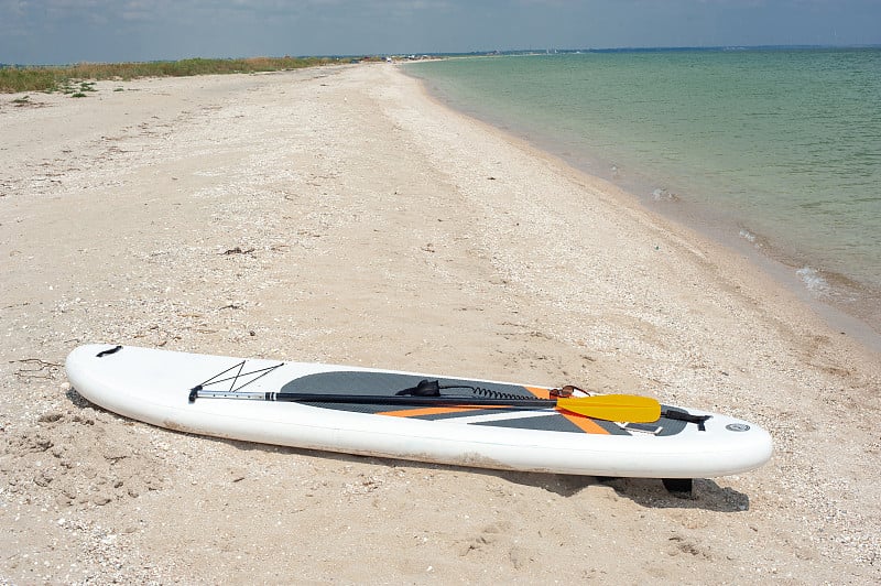 SUP board, stand up paddle near the sea on the bea