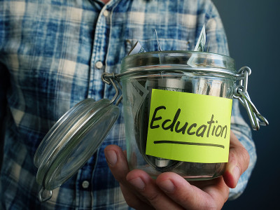 Jar with dollars and the inscription Education. Th