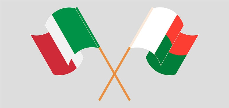 Crossed and waving flags of Madagascar and Italy